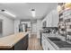 Bright kitchen with white cabinets, wood countertops, stainless steel appliances and open layout at 4172 Stonehenge Rd, Mulberry, FL 33860