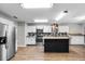 Modern kitchen featuring white cabinets, stainless steel appliances, and a center island with butcher block at 4172 Stonehenge Rd, Mulberry, FL 33860