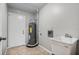 Functional laundry room features tiled floors, utility sink, and water heater at 4172 Stonehenge Rd, Mulberry, FL 33860