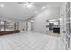 Bright and airy living room featuring an open concept, tile floors, and a view of the modern kitchen at 4172 Stonehenge Rd, Mulberry, FL 33860