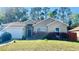 Charming single-story home features a well-manicured lawn and attached two-car garage at 419 Cierra Oaks Cir, Lady Lake, FL 32159