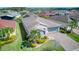 Overhead view of a grey single-story home with a brick driveway, mature landscaping, and a two-car garage at 461 Treviso Dr, Kissimmee, FL 34759