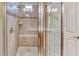 Tiled shower with glass door and built in seating at 461 Treviso Dr, Kissimmee, FL 34759