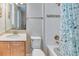 Clean bathroom featuring a shower with tub, framed mirror, and wood vanity at 461 Treviso Dr, Poinciana, FL 34759