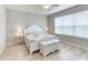 Bright bedroom with a white furniture set, including a bed, two nightstands, and a storage chest at 461 Treviso Dr, Poinciana, FL 34759