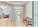 Inviting entryway featuring wood-look tile flooring, tray ceilings, fresh paint, and decorative shelving at 461 Treviso Dr, Poinciana, FL 34759