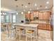 Modern kitchen with stainless steel appliances, quartz countertops, and ample cabinet space, flowing into the dining area at 461 Treviso Dr, Poinciana, FL 34759