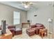 Cozy living room with two red leather armchairs, a ceiling fan, and a wooden desk at 461 Treviso Dr, Poinciana, FL 34759