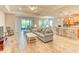 Spacious living room with tile floors, plush seating, and an open layout flowing into the dining area and kitchen at 461 Treviso Dr, Poinciana, FL 34759