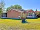 Exterior view of home highlighting a spacious yard and screened in lanai for outdoor enjoyment at 602 N Delmonte Ct, Kissimmee, FL 34758