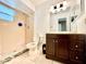 Bathroom featuring a shower, toilet, vanity with countertop, and mirrored lighting at 602 N Delmonte Ct, Kissimmee, FL 34758