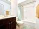 Clean bathroom featuring a shower-tub combo, dark wood vanity, and white tiled walls at 602 N Delmonte Ct, Kissimmee, FL 34758