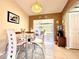 Cozy dining room with natural light, adjacent to a sunroom at 602 N Delmonte Ct, Kissimmee, FL 34758