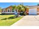 Charming single-story home featuring a well-manicured lawn and a convenient driveway leading to the garage at 602 N Delmonte Ct, Kissimmee, FL 34758