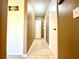 Hallway with neutral colored walls, tile flooring, and a closet for storage space at 602 N Delmonte Ct, Kissimmee, FL 34758