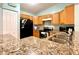 Inviting kitchen featuring granite countertops and stainless steel sink at 602 N Delmonte Ct, Kissimmee, FL 34758