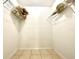 A simple walk-in closet with wire shelving and tiled floor for organized storage at 602 N Delmonte Ct, Kissimmee, FL 34758