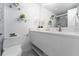 Bathroom featuring modern sink, stylish tile flooring, glass shelving, and a glass enclosed shower at 6165 Carrier Dr # 2108, Orlando, FL 32819