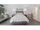 Bright bedroom featuring a queen bed, bedside tables, and a small sofa at 6165 Carrier Dr # 2108, Orlando, FL 32819