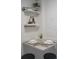 Close up of dining area with place settings, flowers and decorative shelves at 6165 Carrier Dr # 2108, Orlando, FL 32819