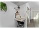 Bright dining nook with seating for two, floating shelves and greenery decor at 6165 Carrier Dr # 2108, Orlando, FL 32819