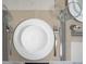 Overhead view of dining place setting with cutlery, glasses and plates at 6165 Carrier Dr # 2108, Orlando, FL 32819