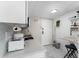 Compact kitchen with white countertops, modern appliances, and adjacent dining area at 6165 Carrier Dr # 2108, Orlando, FL 32819