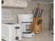 Close-up of kitchen appliances including a toaster, coffee maker, and knife block at 6165 Carrier Dr # 2108, Orlando, FL 32819