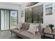 Bright living room featuring a sofa, artwork, large window, and sliding glass door to the patio at 6165 Carrier Dr # 2108, Orlando, FL 32819
