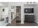 Open concept living space with kitchenette, mirrored closet, and dresser with mounted television at 6165 Carrier Dr # 2108, Orlando, FL 32819