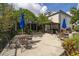 Outdoor patio featuring multiple dining tables, chairs, umbrellas and covered seating area at 6165 Carrier Dr # 2108, Orlando, FL 32819