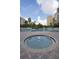Outdoor community pool with a nearby hot tub at 6165 Carrier Dr # 2108, Orlando, FL 32819