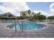 Outdoor swimming pool surrounded by a fence, patio, chairs and lush landscaping at 6165 Carrier Dr # 2108, Orlando, FL 32819