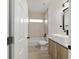 Stylish bathroom features new vanity, neutral tile, and tub with shower at 6862 Se 23Rd Ave, Ocala, FL 34480