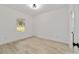 Bright bedroom with light wood floors and white walls is bathed in natural light at 6862 Se 23Rd Ave, Ocala, FL 34480