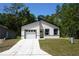Charming single Gathering home boasts a modern exterior with a paved driveway and an attached garage at 6862 Se 23Rd Ave, Ocala, FL 34480