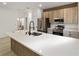 A bright kitchen with stainless steel appliances, modern cabinets, light countertops, and hardwood flooring at 6862 Se 23Rd Ave, Ocala, FL 34480