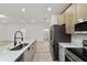 A bright kitchen with stainless steel appliances, modern cabinets, light countertops, and hardwood flooring at 6862 Se 23Rd Ave, Ocala, FL 34480