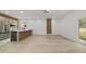 Open-concept kitchen boasts stainless steel appliances and light wood grain cabinets and island with a wine cooler at 6862 Se 23Rd Ave, Ocala, FL 34480
