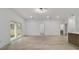 Open-concept living area with light wood floors, sliding glass doors, and a modern breakfast bar at 6862 Se 23Rd Ave, Ocala, FL 34480