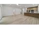 Open-concept living room with stylish flooring and light wood accents, flowing into the kitchen area at 6862 Se 23Rd Ave, Ocala, FL 34480