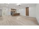Open-concept living space featuring modern wood flooring, stainless steel appliances, and a stylish kitchen island at 6862 Se 23Rd Ave, Ocala, FL 34480