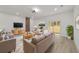 Bright living room with modern decor, ample seating, and a sliding door to the backyard at 6862 Se 23Rd Ave, Ocala, FL 34480