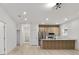 Spacious living room with light wood flooring, recessed lighting, and a modern kitchen in an open floor plan at 6862 Se 23Rd Ave, Ocala, FL 34480