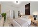 Stylishly designed main bedroom with a modern wood accent wall and an en-suite bathroom with tile shower at 6862 Se 23Rd Ave, Ocala, FL 34480