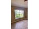 Bedroom featuring tile floor and a window view of a green landscape and lake at 709 Secret Harbor Ln # 213, Lake Mary, FL 32746