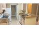 A clean and quaint kitchen with white appliances and washer and dryer at 709 Secret Harbor Ln # 213, Lake Mary, FL 32746