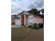 Exterior view of home with garage, large window, and manicured lawn at 7143 Edgewater Shores Ct, Orlando, FL 32810