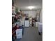 Utility room with washer, dryer, water heater, and ample storage shelves at 7143 Edgewater Shores Ct, Orlando, FL 32810