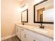 Bathroom featuring double vanity with granite countertop and modern black fixtures at 7848 Somersworth Dr, Kissimmee, FL 34747